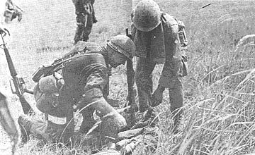 SFC Donald Neal checks wounded NVA